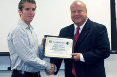 Intern accepts graduation certificate.